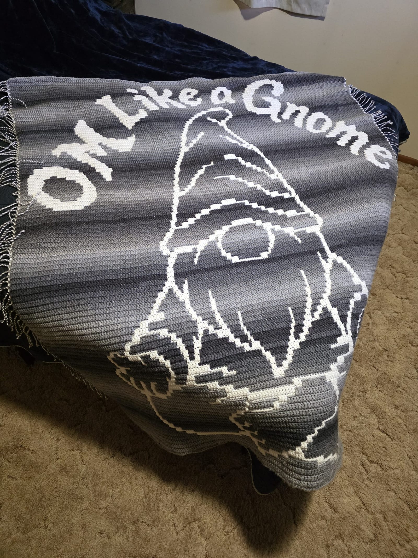 Om Like a Gnome blanket on corner of queen sized bed