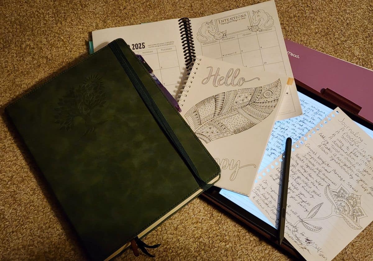 Paper journal with paper planner and Kindle Scribe for note taking.
