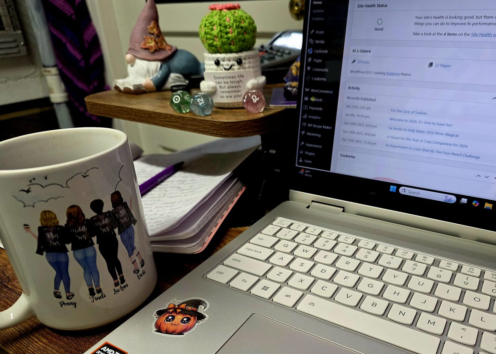 Laptop, mug, notebook, messy desk