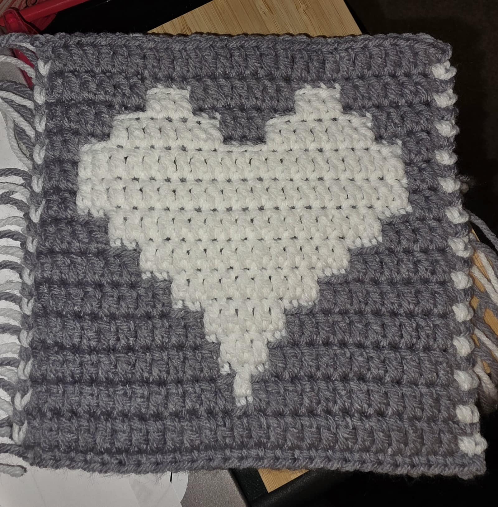 Heart block pattern sample completed with white heart and gray background