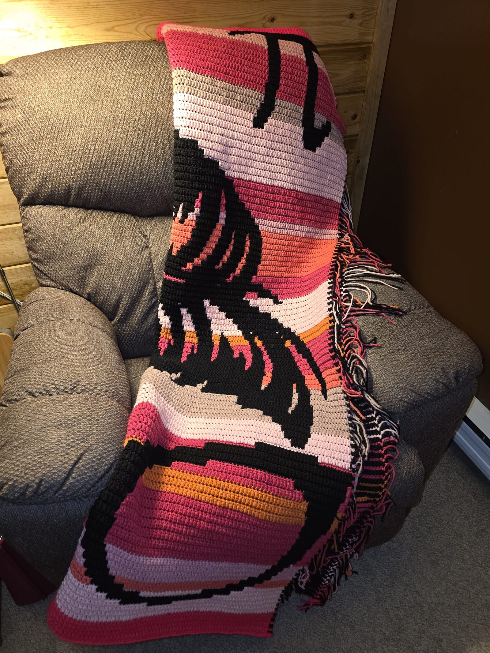 QT Pi afghan half-fold lengthwise on recliner