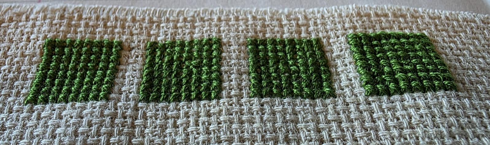 Four green squares filled with varying stitch directions and number of strands