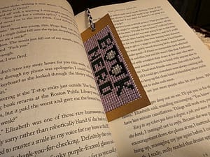 book nerd bookmark in place in open book